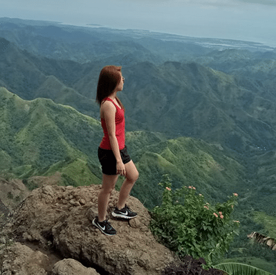 woman standing on mountain top
